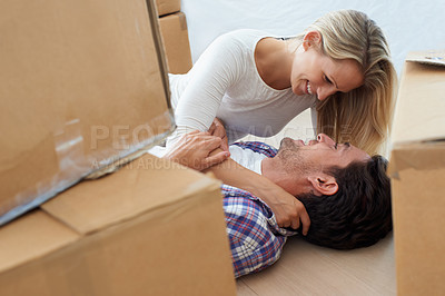 Buy stock photo Couple, boxes and happy or excited for real estate, new home or property investment with romance or love. Moving, man and woman with smile, hug or embrace for fresh start, achievement or dream house