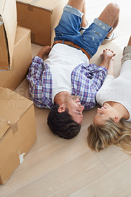 Buy stock photo Couple, boxes and happy on floor for real estate, new home or property investment with romance or love. Moving, man and woman with smile or holding hands for fresh start, achievement and dream house