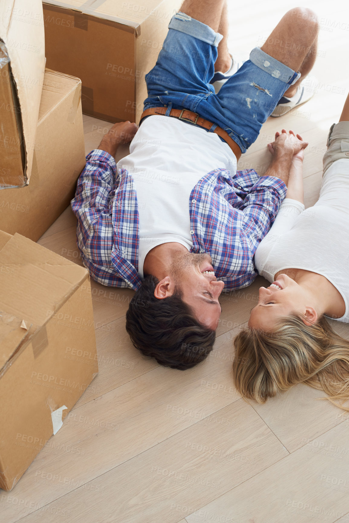 Buy stock photo Couple, boxes and happy on floor for real estate, new home or property investment with romance or love. Moving, man and woman with smile or holding hands for fresh start, achievement and dream house