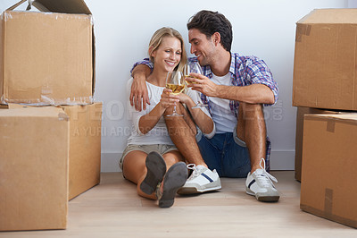 Buy stock photo Cheers, boxes and couple with champagne in new home living room for unpacking and moving together. Happy, love and young man and woman from Australia with wine and cardboard packages in apartment.