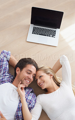 Buy stock photo Happy couple, touch and living room floor with laptop, marriage and relax for love, home and tech. Wife, husband and smile for commitment, bonding together and care for relationship, man or woman
