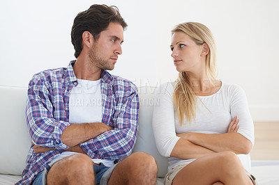 Buy stock photo Couple, angry and living room couch with disagreement, upset and staring with anger, fight or mad. Divorce, betrayal and relationship with cheating, stress and argument for marriage, home or toxic