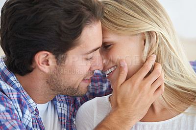 Buy stock photo Happy couple, romantic and kissing with hug, marriage and embrace for love, home and couch. Wife, husband and smile for commitment, bonding together and intimate for relationship, man and woman
