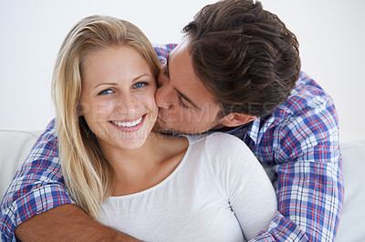 Buy stock photo Happy couple, portrait and kissing with hug, marriage and embrace for love, home and couch. Wife, husband and smile for commitment, bonding together and care for relationship, man and woman
