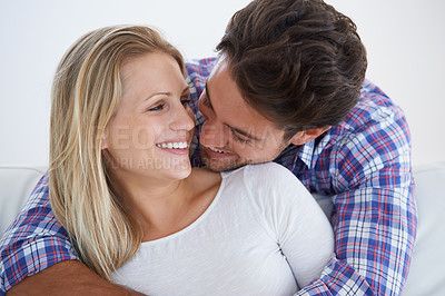 Buy stock photo Happy couple, smile and romance with hug, marriage and embrace for love, home and couch. Wife, husband and house for commitment, bonding together and soulmate for relationship, man and woman
