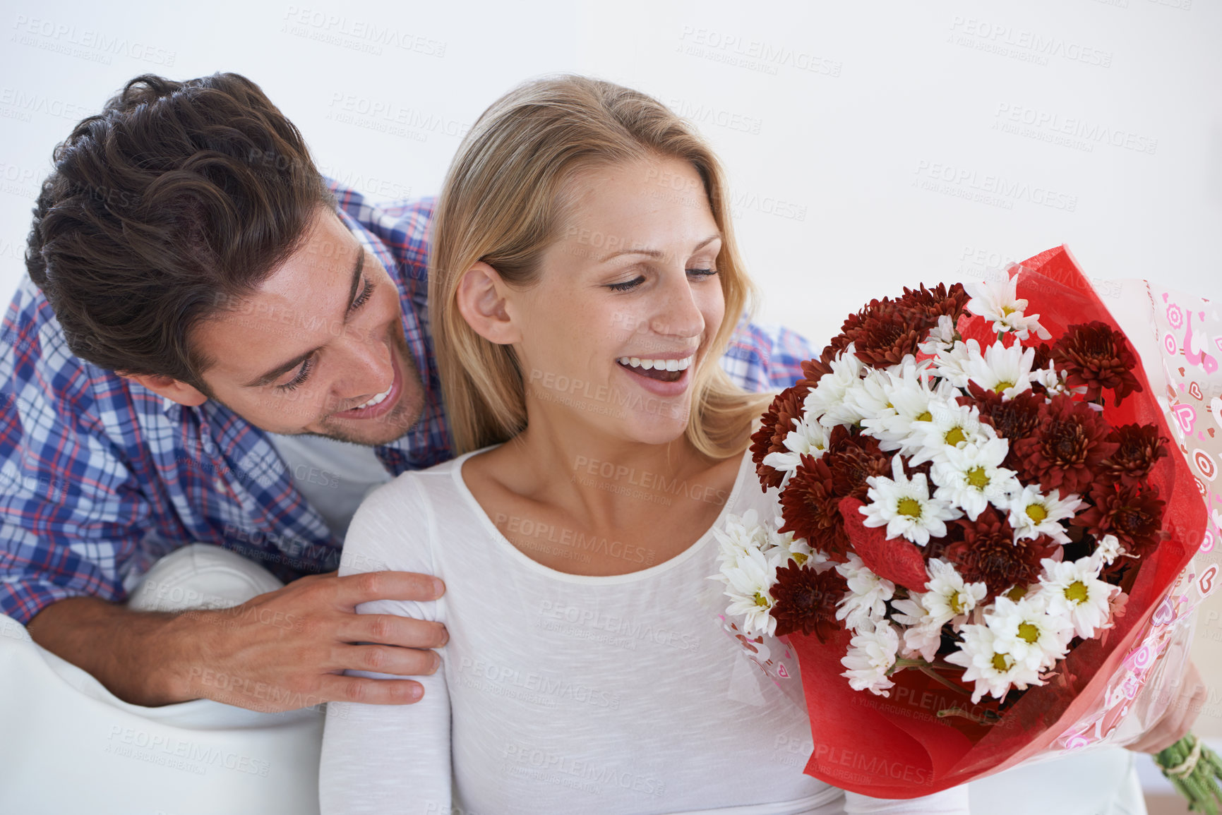 Buy stock photo Wow, surprise or happy couple with flowers in home with hug or care for anniversary celebration. Giving a gift, romance or bouquet for love, present and valentines day with romantic gesture and smile