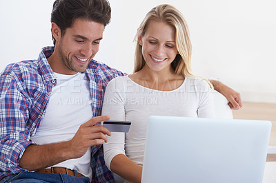 Buy stock photo Happy couple, laptop and credit card for ecommerce, payment or banking together in relax at home. Man and woman smile with debit on computer for online shopping, transaction or fintech at house