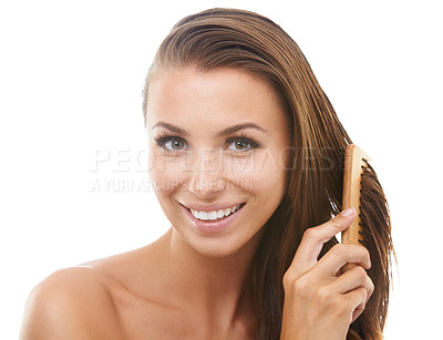Buy stock photo Beautiful young woman brushing her hair while isolated against a white background