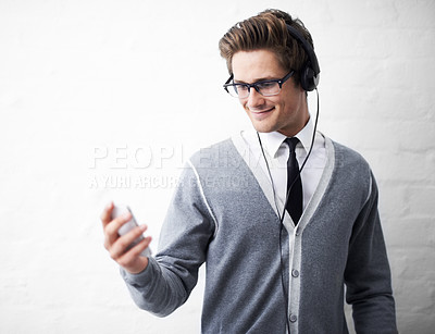 Buy stock photo Man, headphones and listening to audio and relaxing to music by wall background, sound and peace. Male person, smartphone and streaming radio or podcast, playlist and hearing song and mobile app