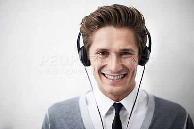 Buy stock photo Business man, portrait and headphones for music, smile and listening to radio by wall background. Employee, person and happy with sound, hearing and audio streaming subscription for podcast with tech
