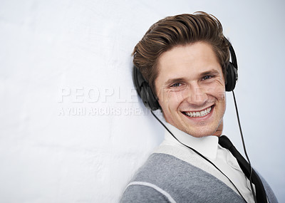 Buy stock photo Business man, portrait and headphones by wall background for music, smile and listening to radio. Employee, person and happy with audio streaming, sound or subscription for podcast by mockup space