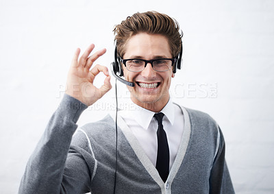 Buy stock photo A smiling young support technician giving you the ok sign