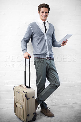 Buy stock photo Business man, case or luggage with tablet, portrait and smile with app, flight or travel by wall background. Entrepreneur, person or employee with digital touchscreen, bag and happy for immigration