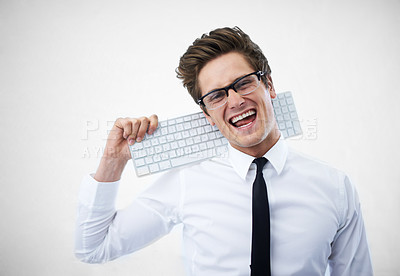 Buy stock photo A young nerdy guy resting his keyboard on his shoulder