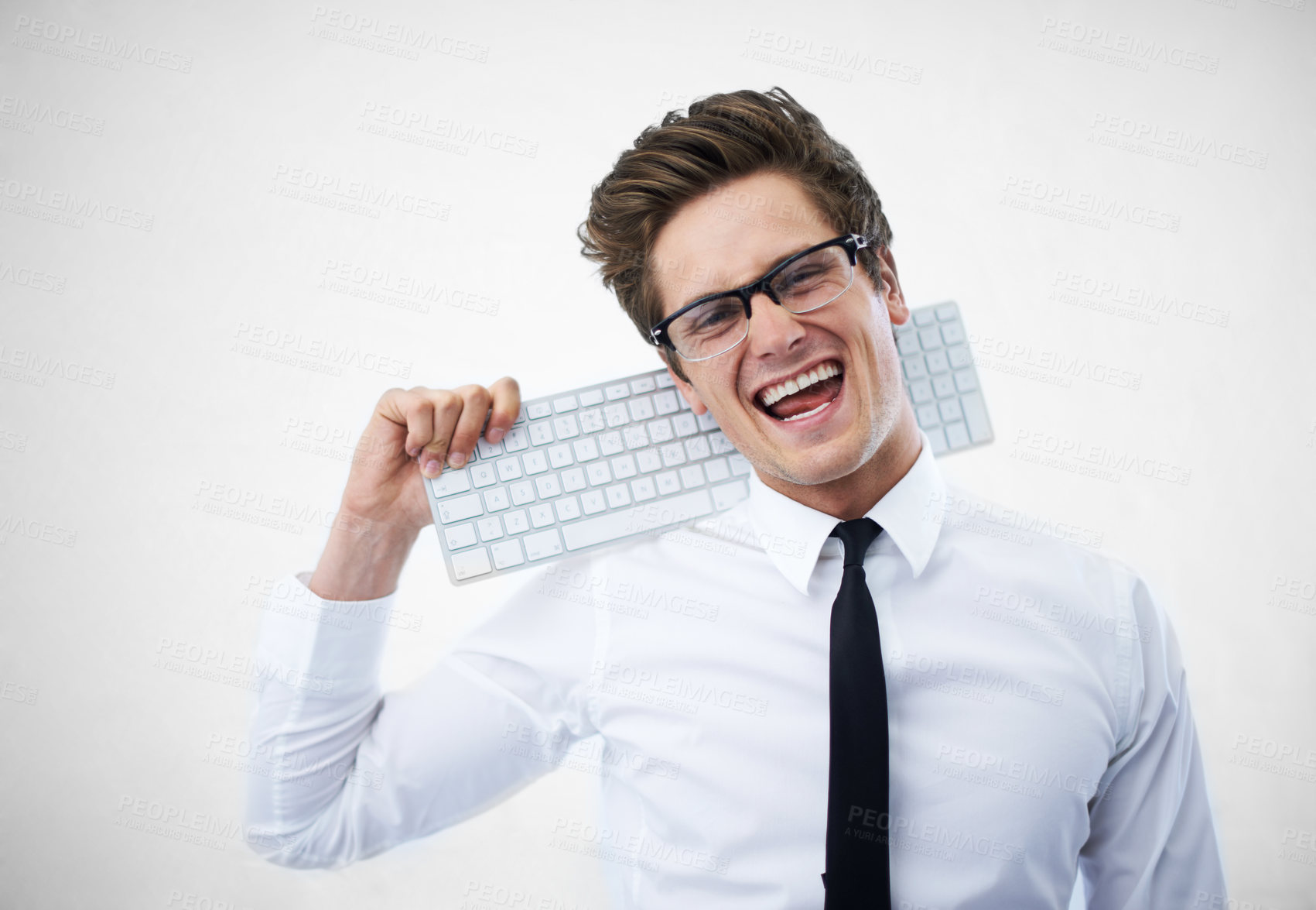 Buy stock photo A young nerdy guy resting his keyboard on his shoulder
