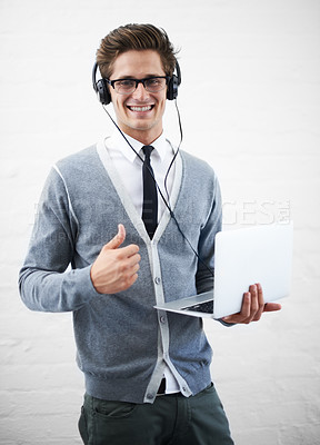 Buy stock photo Happy man, portrait and laptop with headphones, thumbs up or winning on a gray studio background. Male person, nerd or geek smile with computer, like emoji or yes sign for good job on mockup space