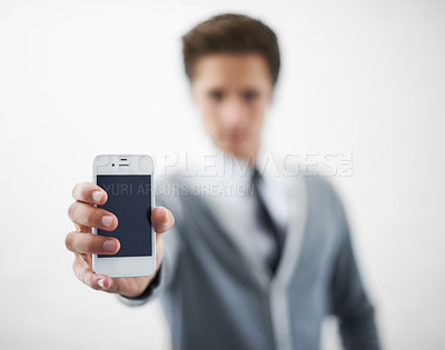 Buy stock photo Man, hands and phone screen for advertising or marketing against a gray studio background. Closeup of male person or employee showing mobile smartphone or tech display for online app on mockup space