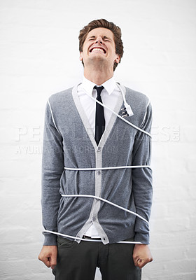 Buy stock photo Man, electrician and tied with cord, boss and portrait for employee, work, angry or job. Frustrated, employer and furious on white background, problem or failure with bad news, stress or risk
