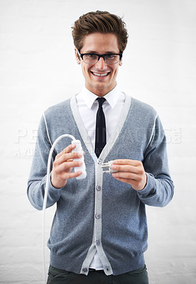 Buy stock photo Business man, portrait and plug with cable, connection or smile for electricity by wall background. Person, employee or entrepreneur for electronics, wire or happy for power, energy and link at job