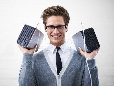 Buy stock photo A young nerd holding up two hard drives