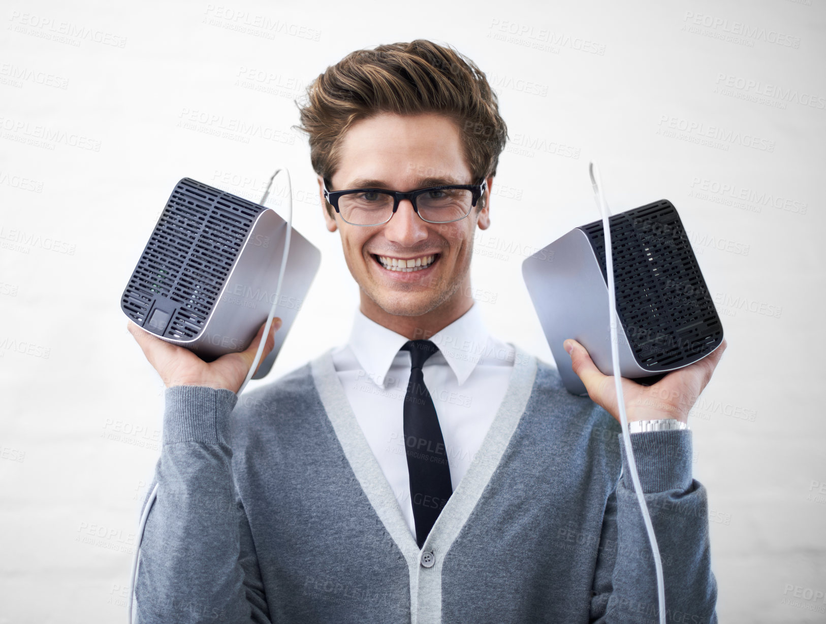 Buy stock photo A young nerd holding up two hard drives