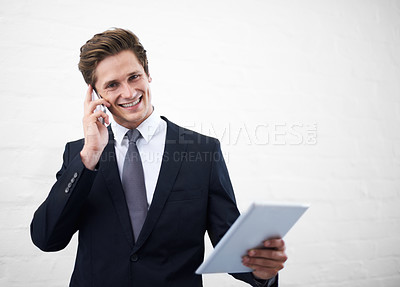 Buy stock photo Business man, phone call and tablet by wall, portrait and contact for networking by white background. Entrepreneur, employee or person with touchscreen, smartphone and mockup space for negotiation