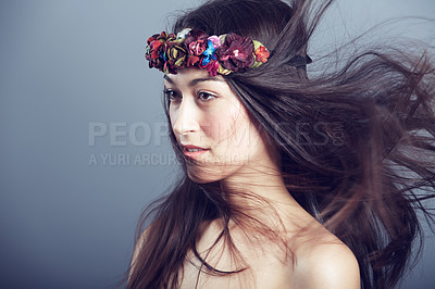 Buy stock photo Woman, flower crown and wind in hair for beauty, skin glow and wellness on grey background. Keratin treatment, hairstyle with floral headband or accessory, dermatology and cosmetics in studio