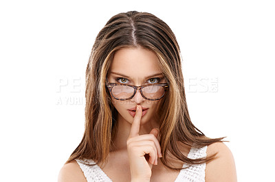 Buy stock photo Woman, secret and finger on lips for portrait, quiet and whisper hand gesture with glasses in white background. Model, face and silence hands for hush expression or peekaboo eyes isolated in studio