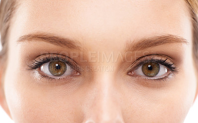 Buy stock photo Face, eyes and vision with a woman in studio on a white background for eyecare or prescription eyewear. Microblading, makeup and zoom with a young female looking closeup while testing fher eyesight