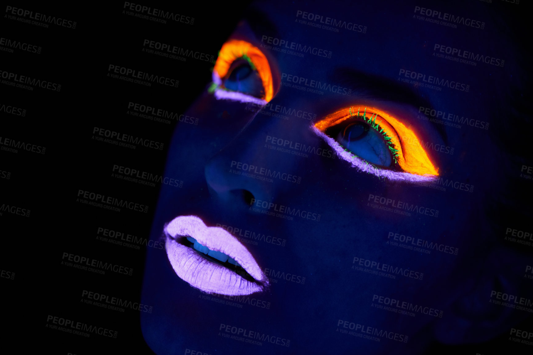 Buy stock photo A young woman with with neon paint on her face posing