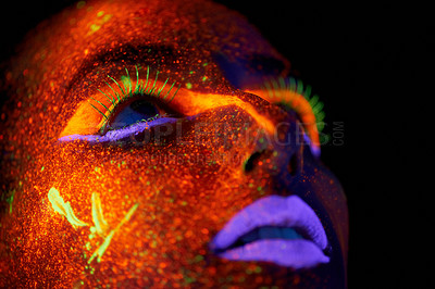Buy stock photo Art, woman with neon paint on face and beauty, closeup with bright lipstick and creative skincare on dark background. Orange glow, disco aesthetic and model in studio for creativity with makeup