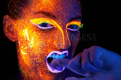 Buy stock photo Art, woman with neon face paint and beauty, portrait with bright lipstick and creative skincare on dark background. Orange glow, disco aesthetic and model in studio for creativity with makeup