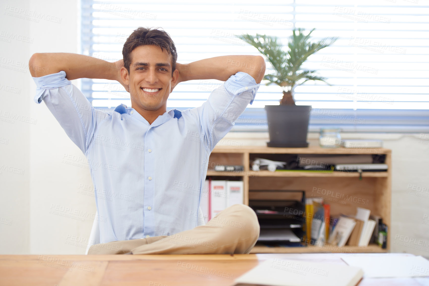 Buy stock photo Portrait, relax or happy man in office on break for mental health, pride or wellness at his desk. Calm, freedom or male employee with smile or hand behind his head in a business stretching or resting