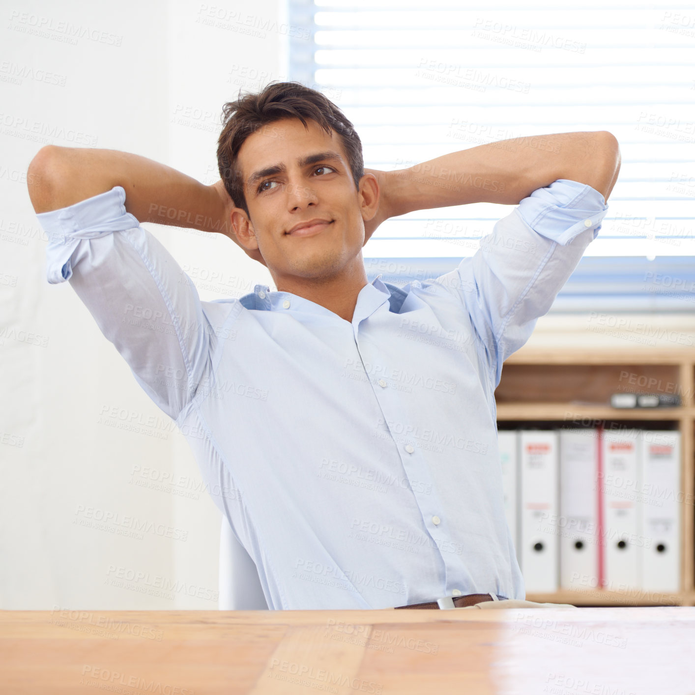 Buy stock photo Thinking, relax or happy man in office on break for mental health, pride or wellness at his desk. Calm, ideas or male employee with smile or hand behind his head in a business stretching or resting