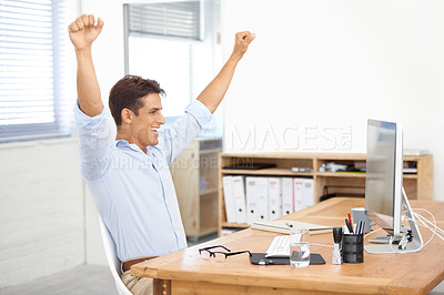Buy stock photo Happy businessman, fist pump and celebration for winning, success or bonus promotion at office. Excited man or employee smile by desk or table for prize, deal or good news on computer at workplace