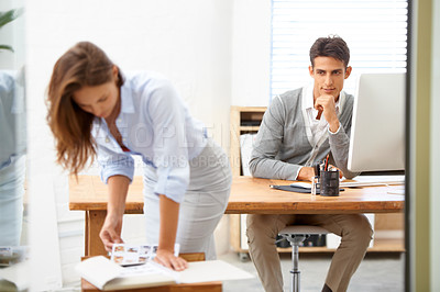 Buy stock photo A young businessman checking out his female co-worker