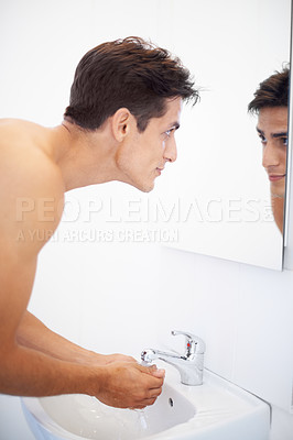 Buy stock photo Man, washing hands and water for hygiene in mirror, clean and protection from bacteria. Male person, bathroom and wellness in morning routine, reflection and grooming or self care and basin at home