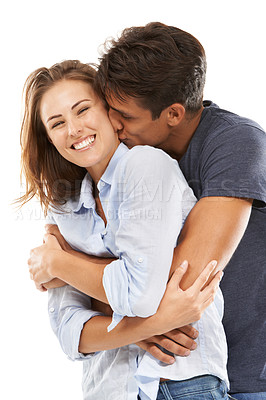 Buy stock photo Happy couple, portrait and hug or kiss in embrace for compassion, love or care on a white studio background. Handsome man and young woman smile for romance, affection or joyful relationship together