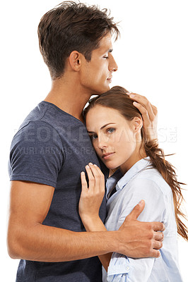 Buy stock photo A young couple embracing lovingly against a white background