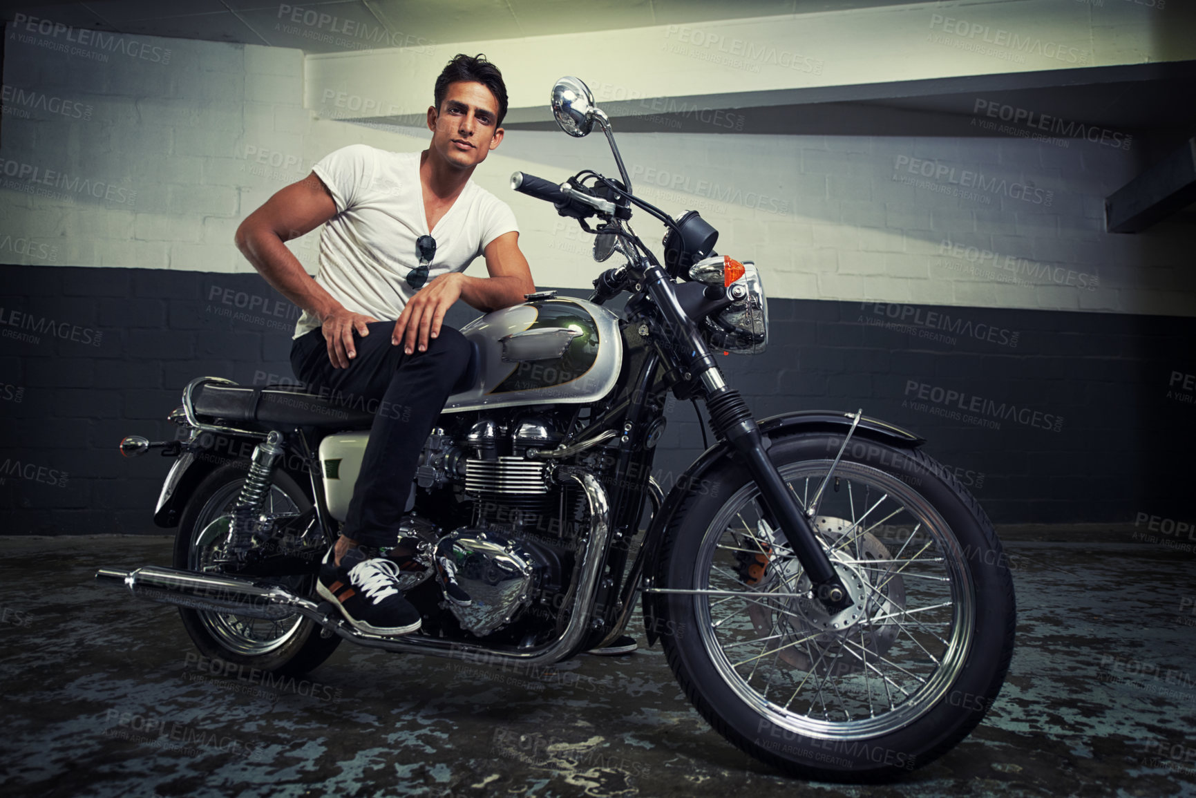 Buy stock photo A handsome young man sitting on his motorcycle