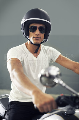 Buy stock photo A handsome young man sitting on his motorcycle