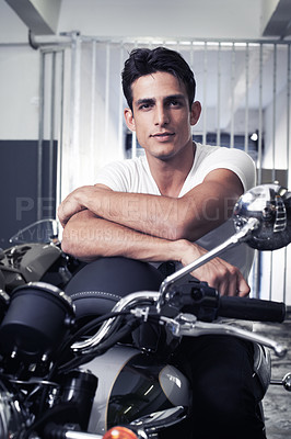 Buy stock photo A handsome young man sitting on his motorcycle