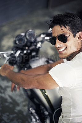 Buy stock photo A handsome young man sitting on his motorcycle