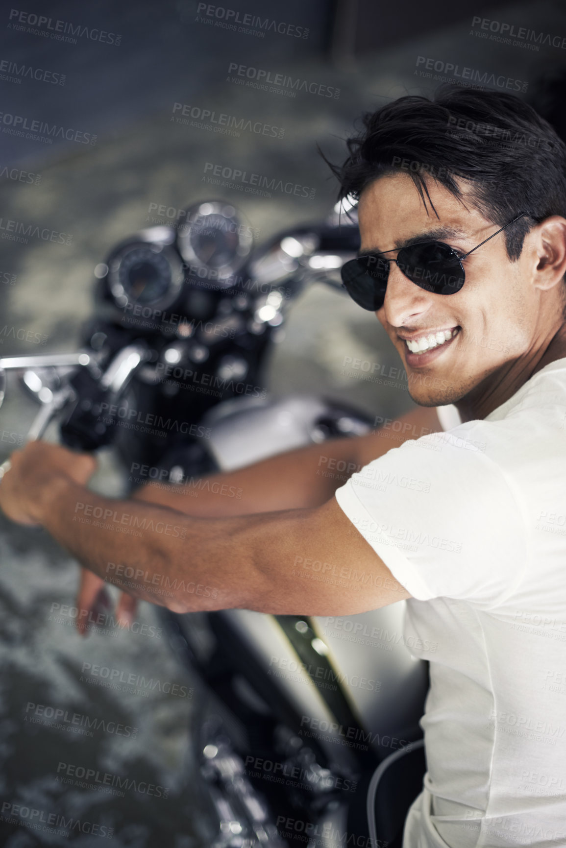 Buy stock photo A handsome young man sitting on his motorcycle