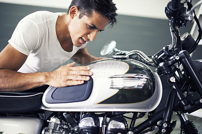 Buy stock photo Handsome man, motorcycle and looking at bike in garage for transportation or vehicle inspection. Young male person or biker admiring motor, engine or cool mechanical power on motorbike in parking lot