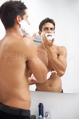 Buy stock photo Man, shaving cream and applying in mirror for hair removal in bathroom, beauty and wellness. Male person, skincare and cosmetics or cleaning in morning routine, grooming and reflection at home