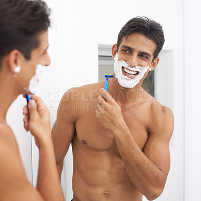 Buy stock photo Man, grooming and razor in mirror for hair removal in bathroom, beauty and wellness. Happy male person, skincare and cosmetics or cleaning in morning routine, shaving cream and reflection at home
