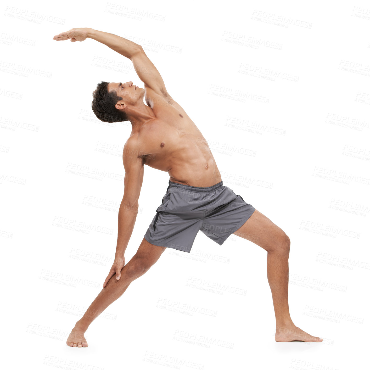 Buy stock photo A handsome young man doing yoga on a white background