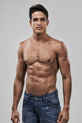 Buy stock photo A handsome young shirtless man posing in studio