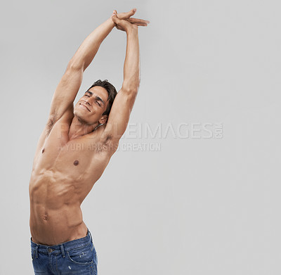 Buy stock photo Man, stretching and fitness pride in studio, relaxing and smiling by gray background. Male person, wellness and confidence for healthy body, muscle development and results or progress by mockup space